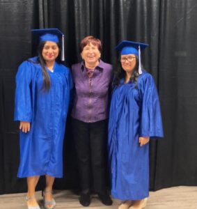 Graduates Sandra Garcia-Justo (left) and Norys Perdomo (right) with their tutor, Beverly Nash, at the AACC ceremony.
